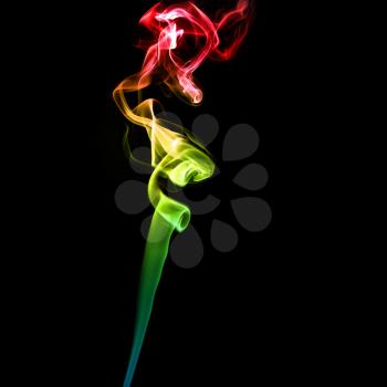 Abstract bright colored smoke on a dark background.