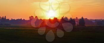 Bright sunset in the countryside. Rural landscape. Panoramic shot. Toned image.