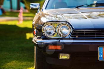 MINSK, BELARUS - MAY 07, 2016: Close-up photo of black Jaguar XJS 1984 model year. Close-up of the front part of an old black classic retro car. Selective focus.