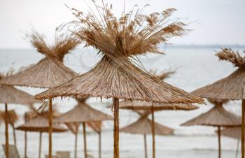 Group of straw umbrellas on the Black Sea in Bulgaria. Shallow depth of field.