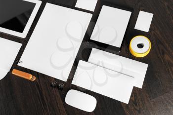 Blank stationery set on dark wooden table background. ID template. Mockup for branding identity for designers.