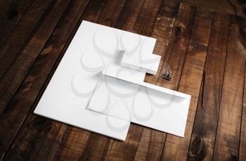 Blank letterhead, business cards and envelope. Photo of blank stationery on wooden table background. Mockup for branding identity. ID template.