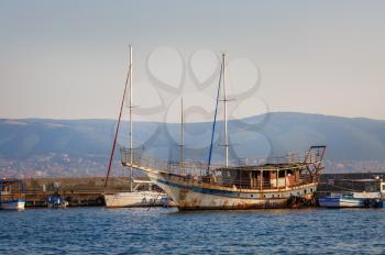 Nesebar, Bulgaria - September 10, 2014: Old rusty ship at the dock in the port of the old town of Nessebar, on the Black Sea coast.