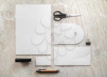 Blank branding mockup. Photo of blank stationery set on light wooden table background. Template for design presentations and portfolios. Top view.