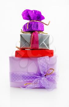 Christmas gifts with decorative ribbons and bows. Colorful gift boxes on a light background.