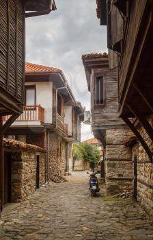 Nesebar, Bulgaria - September 08, 2014: Narrow street and ancient architecture in the old town of Nessebar, Bulgaria. Nesebar is an ancient town on the Bulgarian Black Sea Coast. Vertical shot.