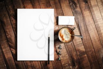 Photo of blank stationery on wooden table background. Responsive design mock up. Blank objects for placing your design. Top view.
