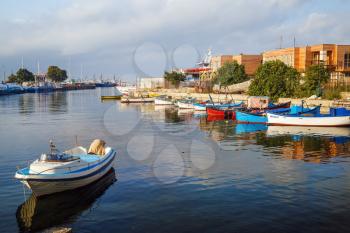Nesebar, Bulgaria - September 05, 2014: Fishing boats at the pier in the harbor of the old town of Nessebar, Bulgaria. Old Nesebar is an ancient town on the Bulgarian Black Sea Coast.