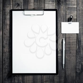 Blank letterhead, badge and pen. Blank ID template on wooden table background. Mock up for placing your design. Top view.