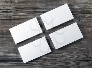 Four blank piles of business cards on wooden table background. Template for placing your design. Blank stationery mock up. Top view.
