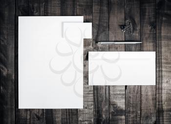 Blank letterhead, business cards, envelope and pen on vintage wooden table background. Blank stationery template for branding identity . Mockup for placing your design. Top view.