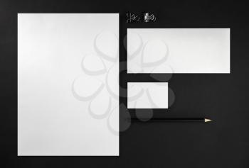 Blank stationery set. Corporate identity template on black background. Mock up for ID. Responsive design mockup. Blank objects for placing your design. Top view.