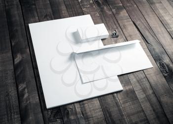 Photo of blank letterhead, business cards and envelope. Blank stationery set on wooden table background. Mock up for branding identity. ID template. Blank corporate identity.