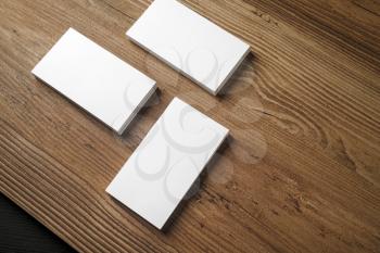 Piles of blank business cards on wood table background. Blank stationery. Mock up for branding identity for placing your design. Top view.