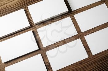 Blank business cards on wooden table background. Blank stationery mockup for branding identity for placing your design. Top view.