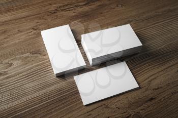 Photo of blank business cards on vintage wood table background. Mock up for ID. Blank template for branding identity.