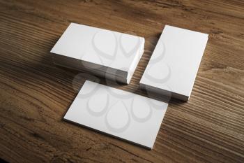 Photo of blank business cards. Blank business cards on wooden table background. Template for ID. Mockup for branding identity.