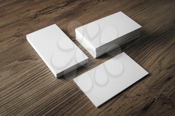 Stacks of blank name cards on wooden table background. Template for branding identity. Business cards mock up.