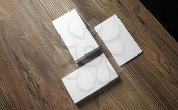 Stacks of blank business cards on wood background. Template for your design. Blank name cards. Top view.