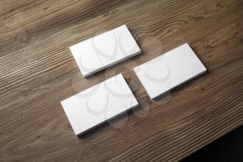 Three stacks of blank business cards on wooden table background. Mock up for branding identity. Blank template for your design.