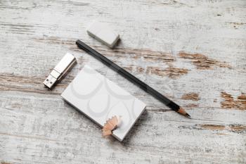 Blank stationery mockup. Bank business cards, pencil, eraser and flash drive on vintage wood table background. Corporate identity template. For design presentations and portfolios. Top view.