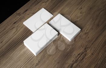 Piles of blank business cards on wood background. Template for your design. Stacks of blank name cards.