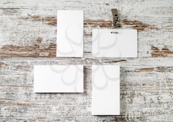 Bank business cards and badge on vintage wooden table background. Mock up for placing your design. Template for ID. Top view.