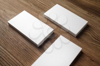 Photo of blank business cards on wooden background. For design presentations and portfolios.
