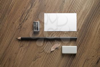 Bank business card, pencil, eraser and sharpener on wood table background. Template for ID. Responsive design mockup. Top view.