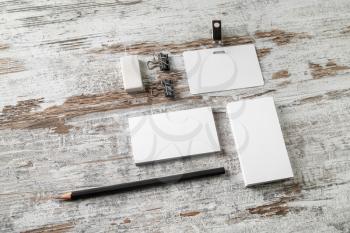 Bank business cards, badge, pencil and eraser on vintage wood table background. Photo of blank stationery and ID template. For design presentations and portfolios.