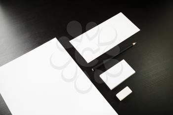 Blank corporate identity template on black wooden table background. Photo of blank stationery. Mock up for design portfolios.