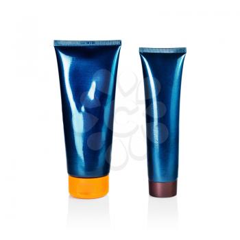 Two blank blue cosmetic tubes on white background. Plastic tube. Beauty product package. Isolated with clipping path.