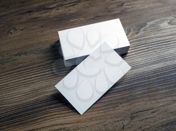 Photo of blank white business cards on a wood table background. Template for ID. Mock up for for branding identity.