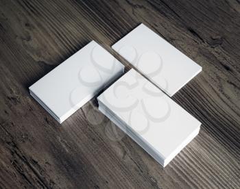 Three stacks of blank business cards on wooden background. Template for your design.