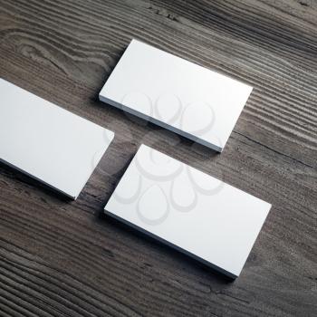 Photo of blank business cards on wooden background. Template for ID. Responsive design mock up. Top view.