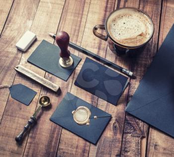 Photo of blank black vintage stationery elements on wood table background. Responsive design mockup. ID template.