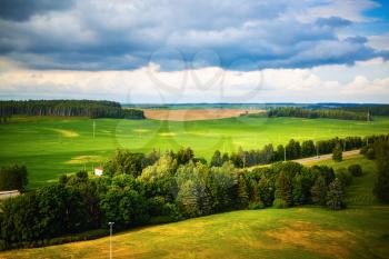 Summer landscape with green meadows, fields, trees and forests. Minsk region, Belarus