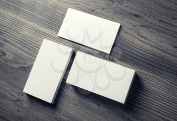 Photo of blank business cards on wooden table background. Template for ID. Mockup for branding identity. Top view.