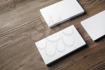 Blank white business cards on wood background. Mock-up for branding identity. Blank template for placing your design. ID mock up.