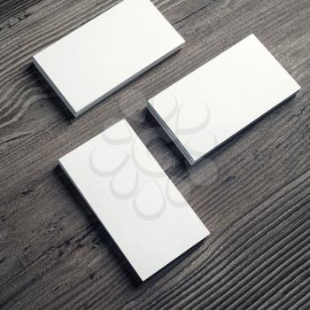 Photo of blank business cards on wood table background. For design presentations and portfolios. Mockup for branding identity.