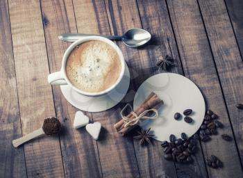 Coffee with spices and sugar on wood table background.