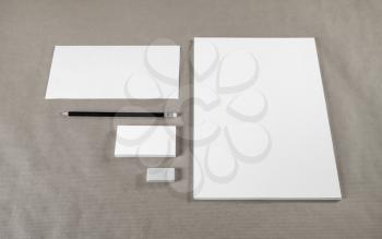 Simple stationery template on craft paper background. Blank envelope, business cards, A4 paper, pencil and eraser.