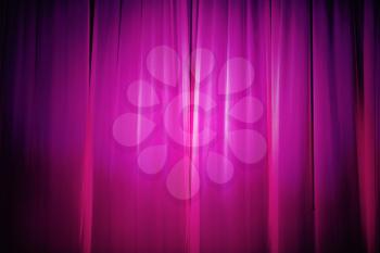 Purple stage curtain with spotlight. Abstract background.