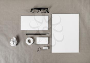 Blank corporate stationery on craft paper background. Branding mock up for graphic designers portfolios. Top view.