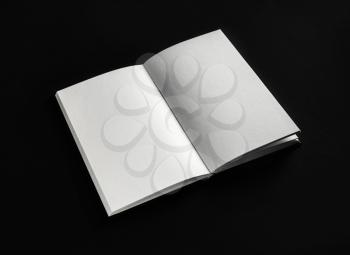 Blank open booklet, book or notebook on black paper background. Responsive design mockup.