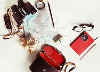 Photo of travel accessories. Top view of personal traveler's items. Vintage toned image. Top view. Flat lay.