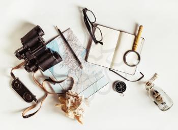 Travel still life. Outfit and accessories of traveler. Vintage toned image. Top view. Flat lay.