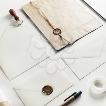 Blank envelopes and stationery set on white paper background. Hand made items for placing your design. Vintage toned image.
