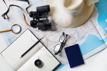 Outfit of traveler on map background. Travel concept. Flat lay.