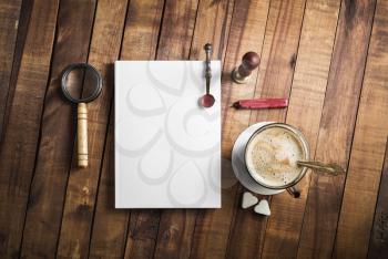 Photo of blank vintage stationery set on wooden background. Responsive design template. Flat lay.